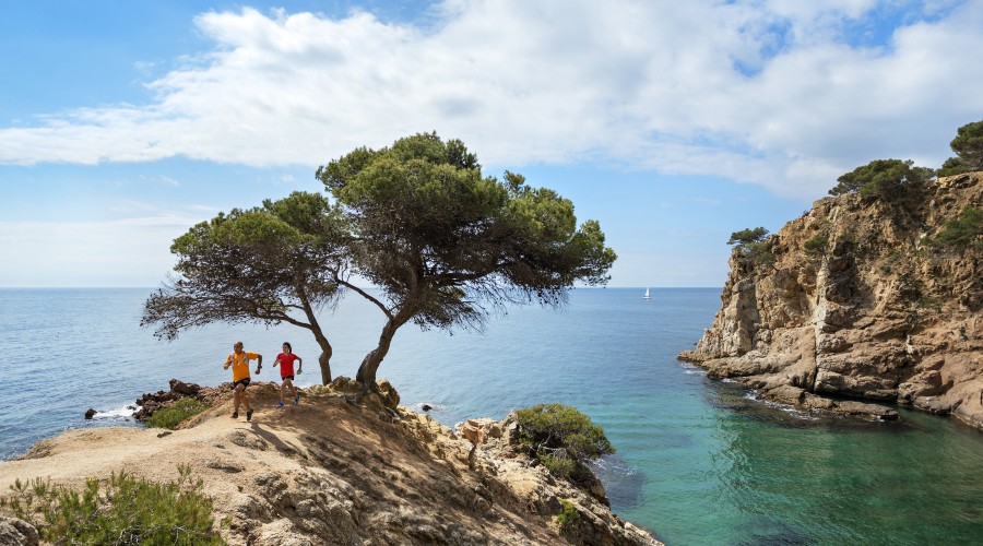 Trail running on the Costa Brava Trail runners above the Mediterranean while on a trail running tour of the Costa Brava